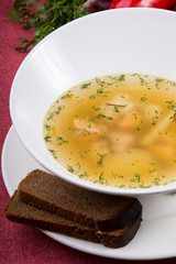 Yellow chicken soup served with leek