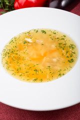 Yellow chicken soup served with leek