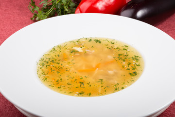 Yellow chicken soup served with leek