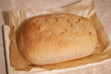 Homemade bread of wheat flour on the wood board