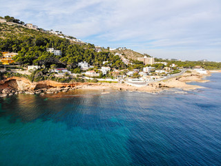 Aerial view of Las Rotas rocky beach in Denia, Spain at sunset