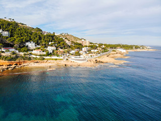 Aerial view of Las Rotas rocky beach in Denia, Spain at sunset