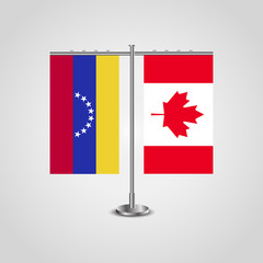 Table stand with flags of Venezuela and Canada. Two flag. Flag pole. Symbolizing the cooperation between the two countries. Table flags