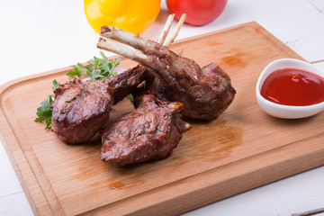 Grilled juicy lamb chop served with ketchup
