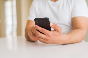 Close up of middle age man hands using smartphone at home