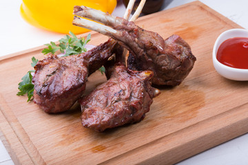 Grilled juicy lamb chop served with ketchup