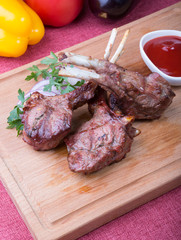 Grilled juicy lamb chop served with ketchup