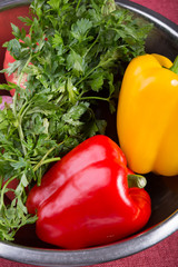 Bell pepper with parsley in a metal bowl in kitchen