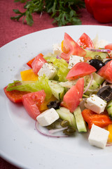 Mixed fresh greek salad on a plate
