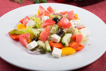 Mixed fresh greek salad on a plate