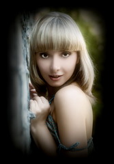 Fototapeta premium Beautiful sexual girl blonde beside sulphur concrete wall