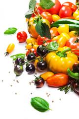 Assorted tomatoes and vegetables isolated on white background. Photo for your design.