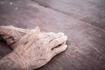 Hands Asian elderly woman grasps her hand on lap, pair of elderly wrinkled hands and Traces of hard...