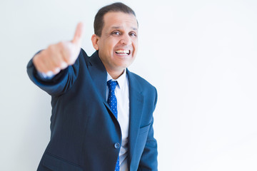 Middle age man doing postive gesture with thumbs up smiling to the camera