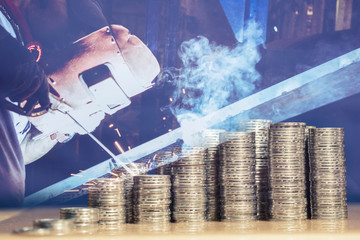 Money stack as growth of return of investment chart, with double exposure of industrial worker welding background.