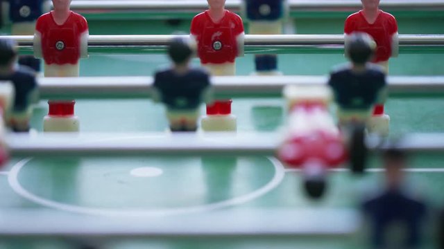 Table football players in a game as people play