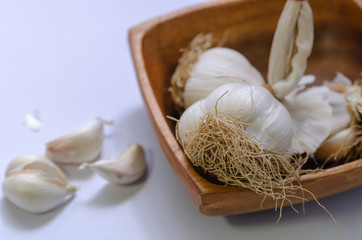 Garlic Cloves and Bulb in wooden bowl.