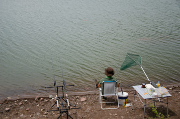 A Fisherman at the lake. fishing rods in the lake.