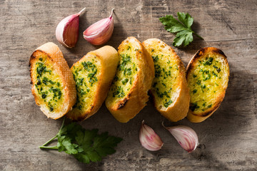 Garlic bread on wooden table. Top view