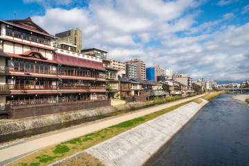 Traditional old Houses at the Promenade along Kamo River next to Shijo Bridge in Gion District, Kyoto, Japan.