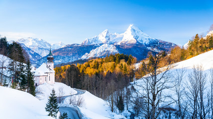 Beautiful winter wonderland mountain scenery in the Alps with pilgrimage church of Maria Gern and famous Watzmann summit in the background, Berchtesgadener Land, Bavaria, Germany