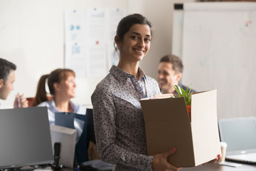 Portrait of new indian female employee or intern holding cardboard box