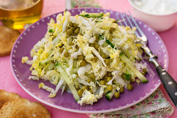 Fresh salad of napa cabbage with cucumbers and peas