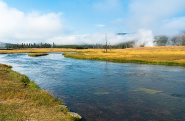 Madison River and steam vents in the distance at Yellowstone National Park, Wyoming, USA