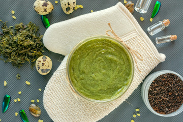 Flat lay body cosmetics concept. Body peeling. Natural facial and body mask or scrub with coffee, sea salt, seaweeds, quail egg and natural oil. © Iryna Bidovska
