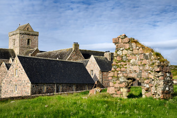 Medieval pink granite stone ruins of the Bishop's House next to the museum at Iona Abbey monastery on Isle of Iona Inner Hebrides Scotland UK