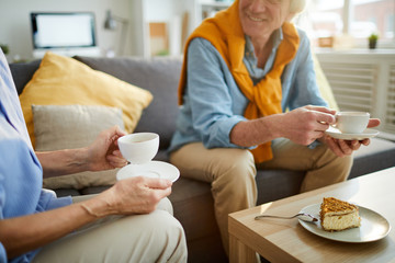 Mid section portrait of unrecognizable mature couple enjoying tea during weekend at home, copy space - Powered by Adobe
