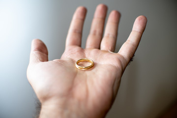 Gold wedding ring resting on a hand
