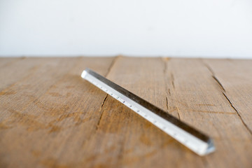Acrylic ruler over wooden countertop