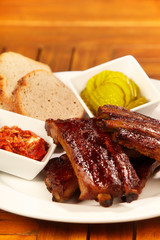 Grilled bbq pork ribs with bread and cucumber