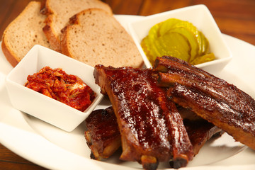 Grilled bbq pork ribs with bread and cucumber