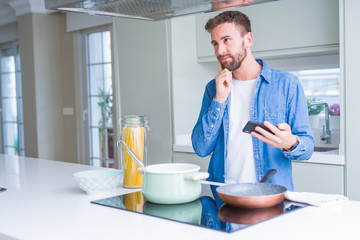 Handsome man cooking pasta at home