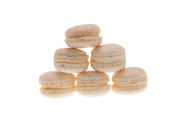 Pile of french white macaroons overs white background