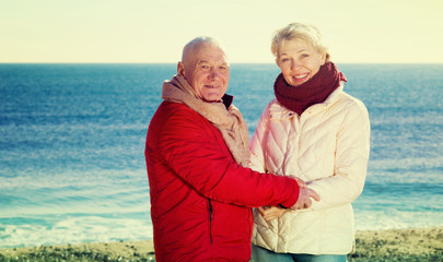 Fototapeta na wymiar Mature couple walking by sea