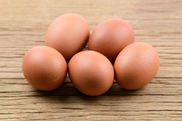 Brown chicken eggs on wooden table isolated on white background