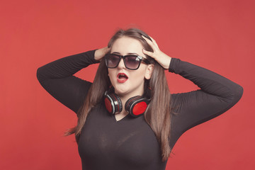 Model plus size with sweet donut, happy girl posing with headphones, in black bodysuit. XXL female...