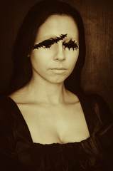 Creepy portrait of young woman without eyes on dark background