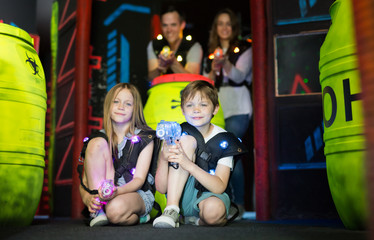 Kids sitting with laser guns