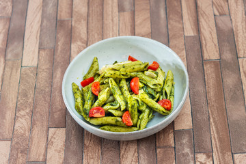 Pasta with pesto sauce and nuts on a the table