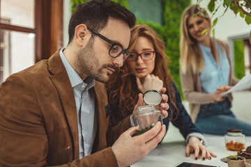 Scientist Examining Samples With Plants