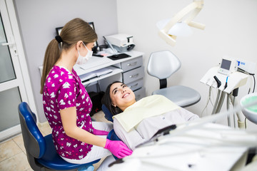 Overview of dental caries prevention.Woman at the dentist chair during a dental procedure. Beautiful Woman smile close up. Healthy Smile. Beautiful Female Smile