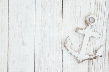 A anchor on weathered whitewash textured wood background © Karen Roach