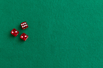 Red dices on green poker gaming table in casino. Concept online gambling.