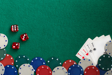 Playing cards,dices and poker chips from above on green poker table