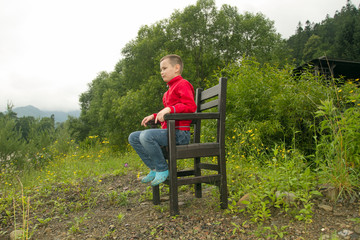 Naklejka na ściany i meble Boy Sitting on Chair in the Forest