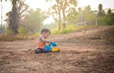 childen playing toy on soil outdoor